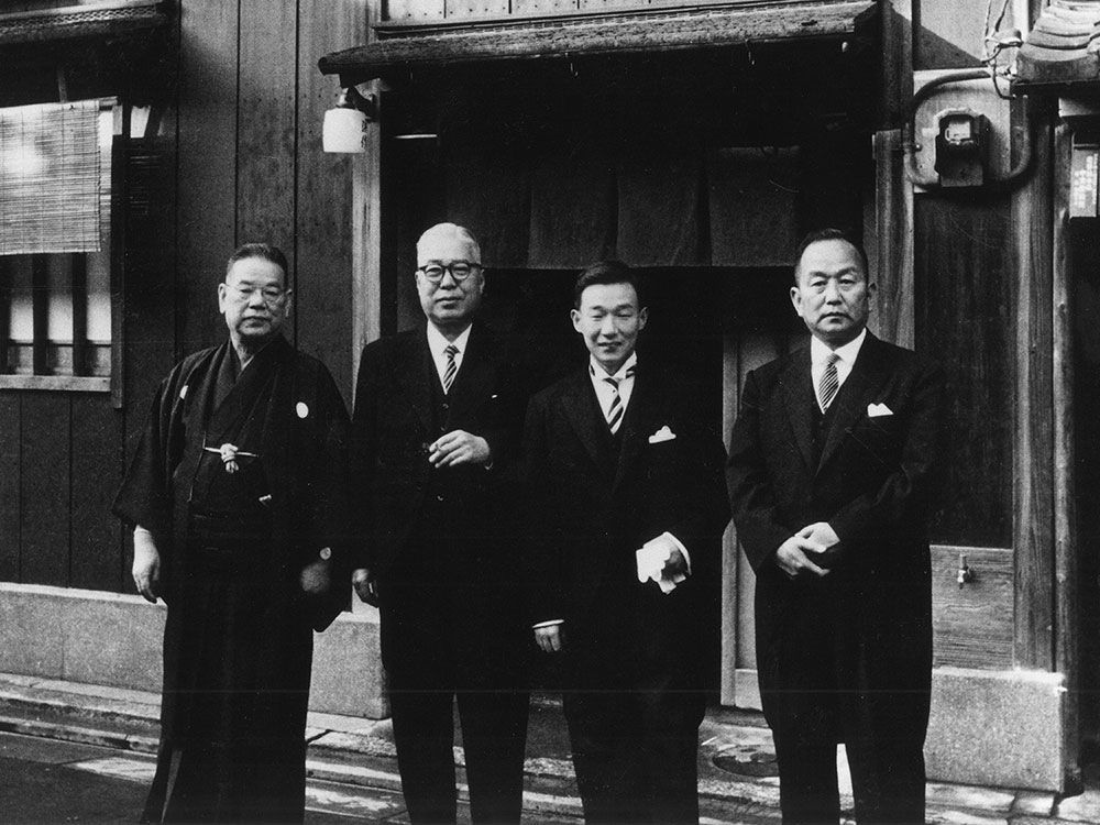 浜作はじめて物語 客前で仕事を魅せる板前割烹料理の発祥である浜作。創業昭和二年からの百年をご紹介します。 写真は創業者森川栄（一番左）と二代目森川武（右から二番目）が写る記念の写真。